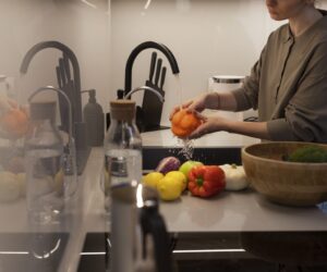 side-view-woman-washing-bell-pepper-min